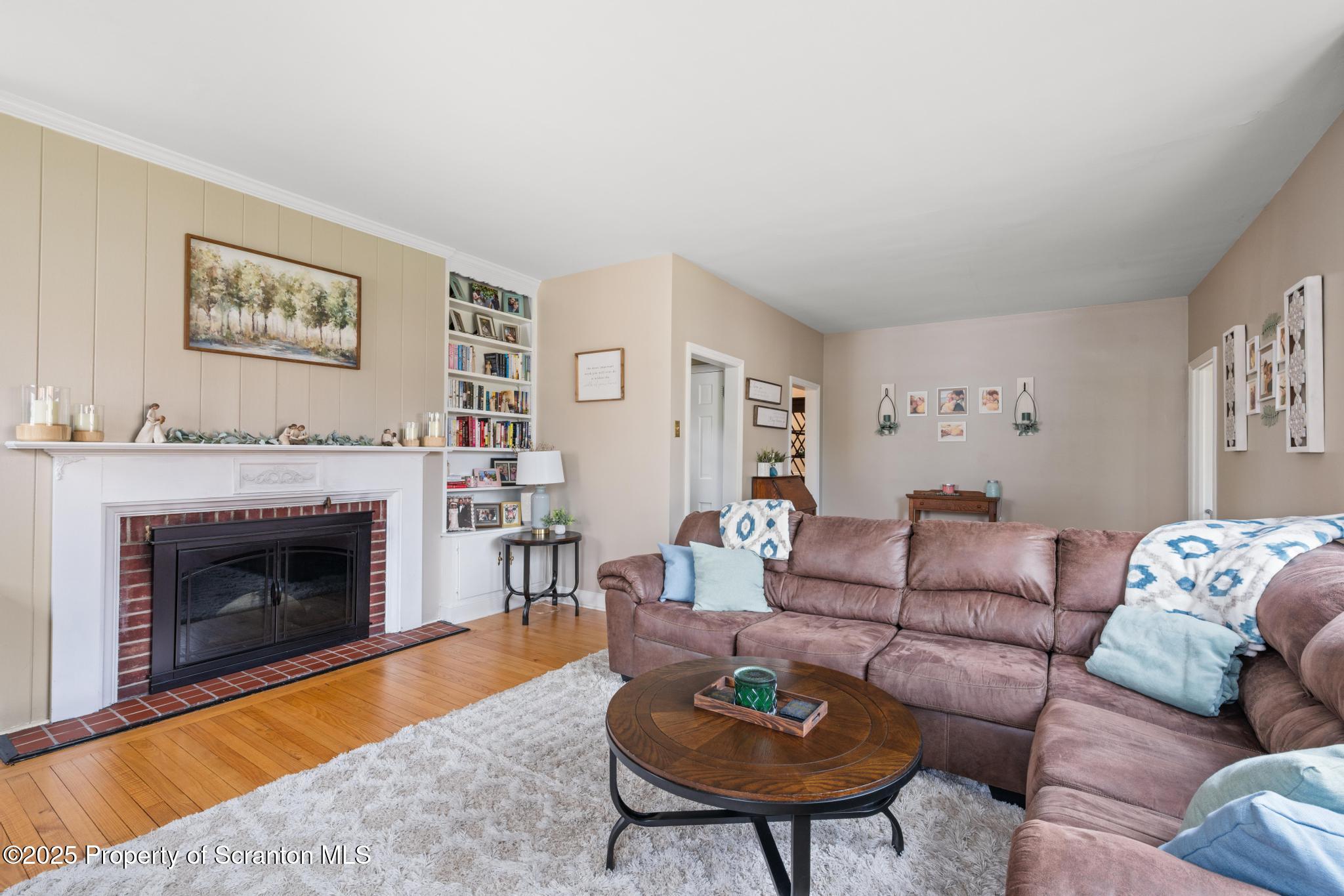 114 Spring Street Clarks Green, PA 18411 - Photo 7 of 47 a living room with furniture and a fireplace