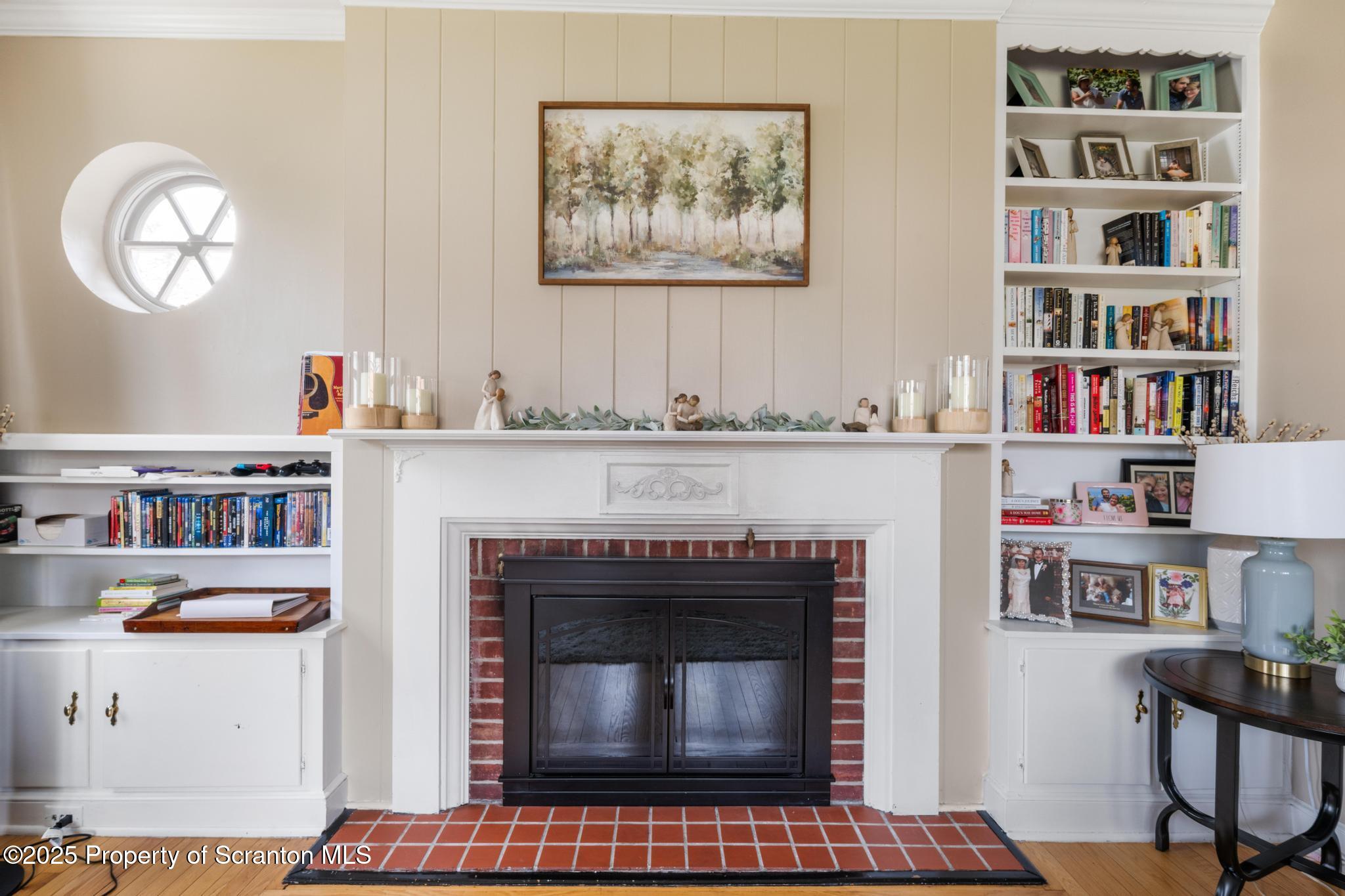 114 Spring Street Clarks Green, PA 18411 - Photo 8 of 47 a living room with lots of books and a fireplace