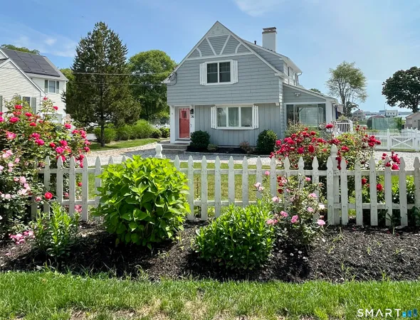 a front view of a house with a yard and fountain