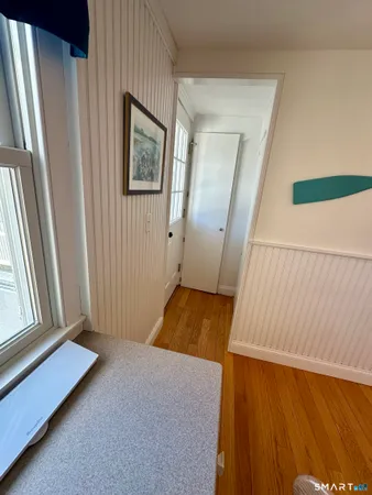 a view of a room with wooden floor and windows