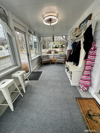 a living room with furniture and a floor to ceiling window