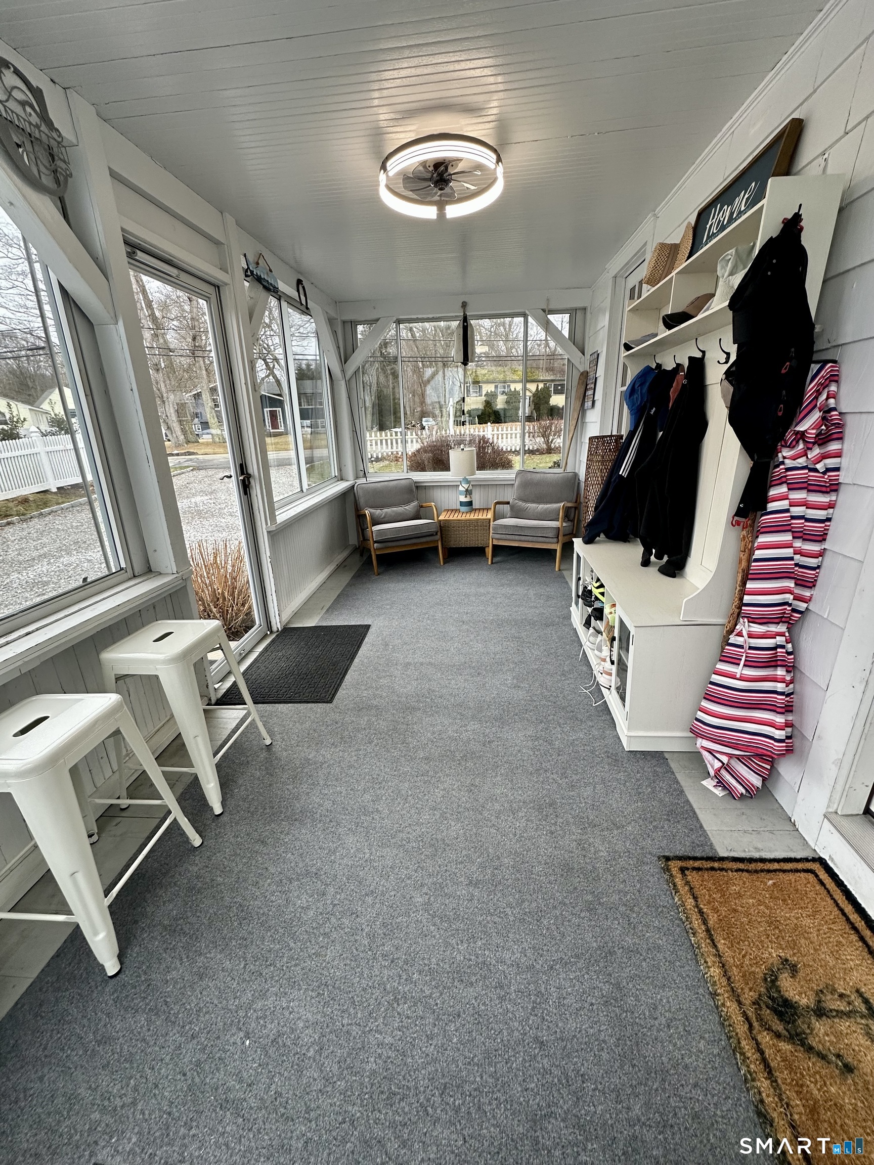 36 Attawan Road East Lyme, CT 06357 - Photo 13 of 40 a living room with furniture and a floor to ceiling window