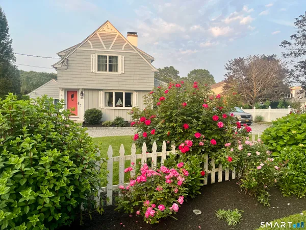 a front view of a house with a yard and fountain
