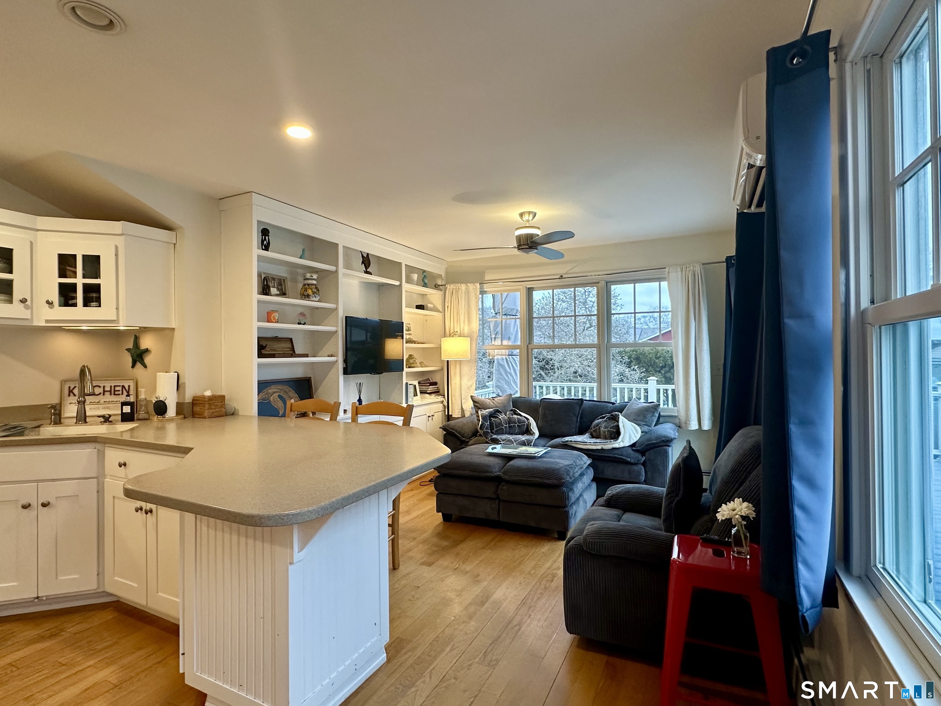 36 Attawan Road East Lyme, CT 06357 - Photo 8 of 40 a living room with stainless steel appliances granite countertop furniture a fireplace and a large window