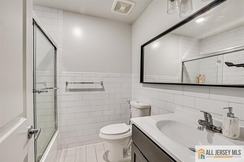 3003 Hana Road Edison, NJ 08817 - Photo 32 of 45 a bathroom with a sink toilet and mirror