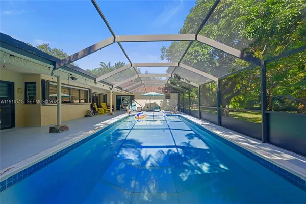 a view of a patio with table and chairs with wooden floor and fence