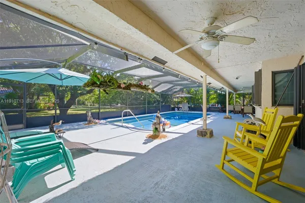 a view of a patio with a table and chairs under an umbrella