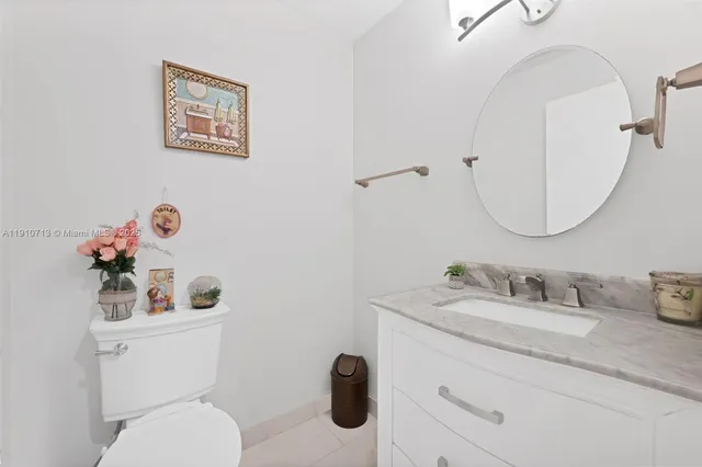 a bathroom with a double vanity sink mirror and toilet