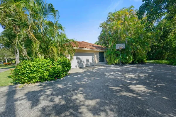 a view of house with outdoor space and garden