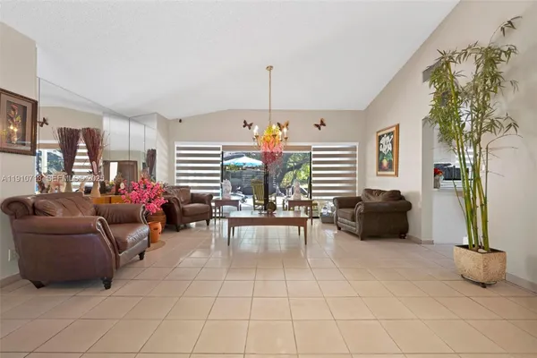 a living room with furniture and a chandelier