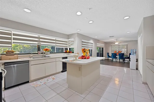 a kitchen filled with white cabinets and a sink