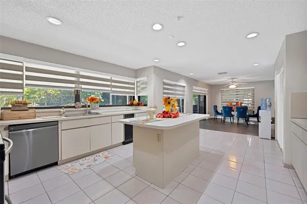 a kitchen filled with white cabinets and a sink