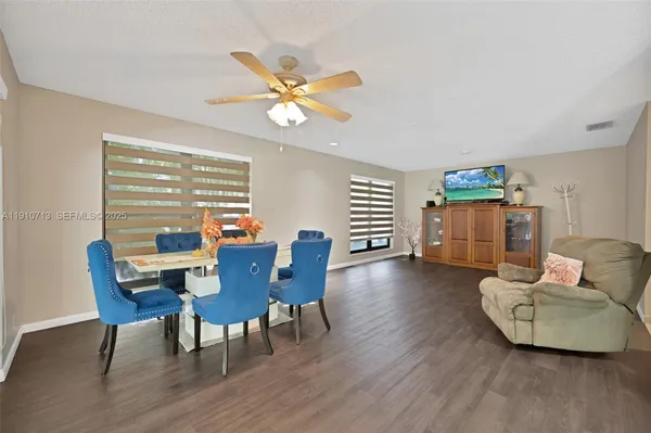 a view of a dining room with furniture and wooden floor