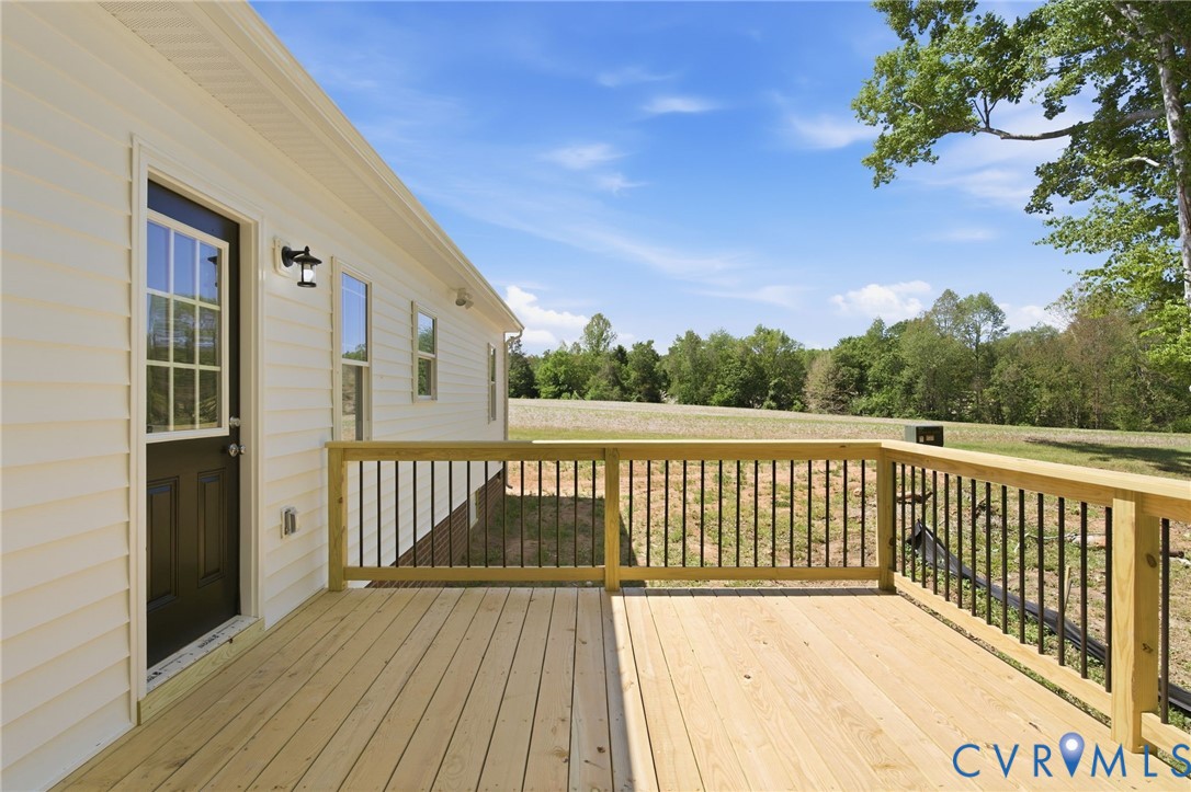 17557 Hewlett Road Beaverdam, VA 23015 - Photo 27 of 29 a view of a balcony with wooden floor and fence