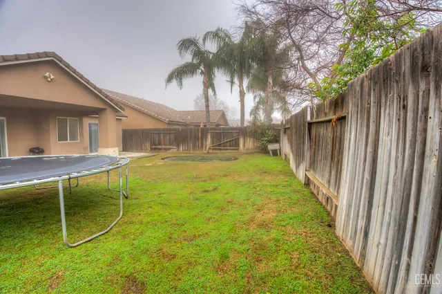 a swimming pool with outdoor seating and yard