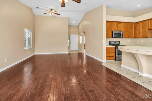a view of a kitchen with wooden floor and a kitchen