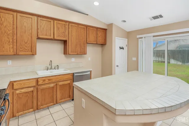 a kitchen with a sink cabinets and appliances