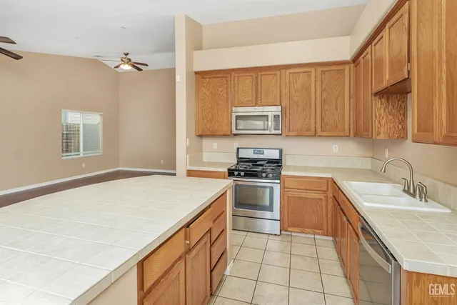 a kitchen with stainless steel appliances a stove sink and microwave