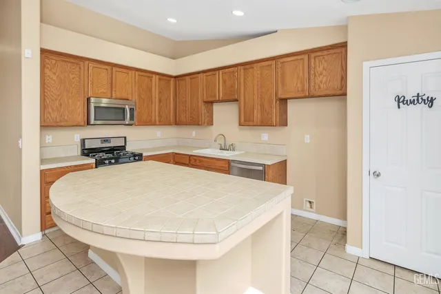 a kitchen with a sink and a stove top oven