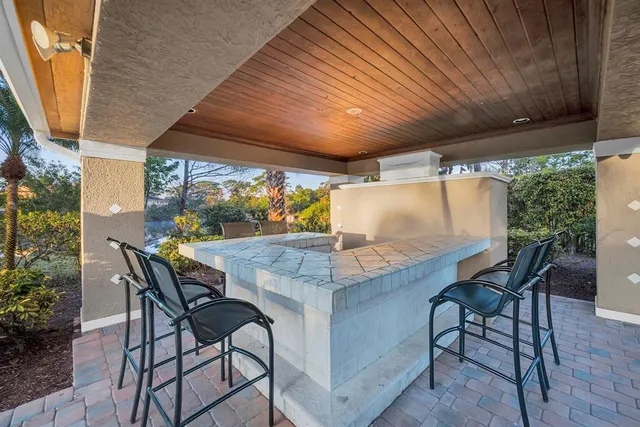 a view of an outdoor dining space with a table and chairs