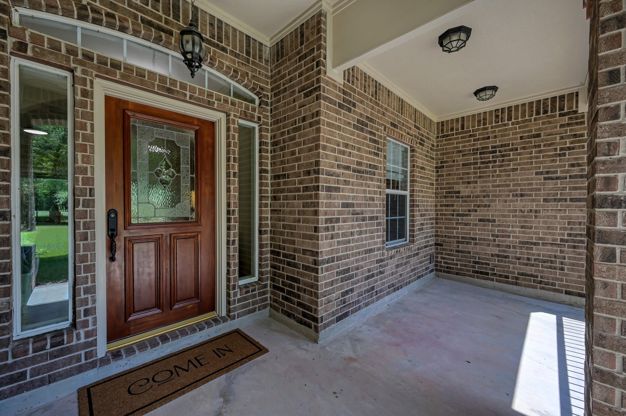 9606 Miller Road Magnolia, TX 77354 - Photo 3 of 41 Enjoy the sunset view just beyond the trees from this front porch.