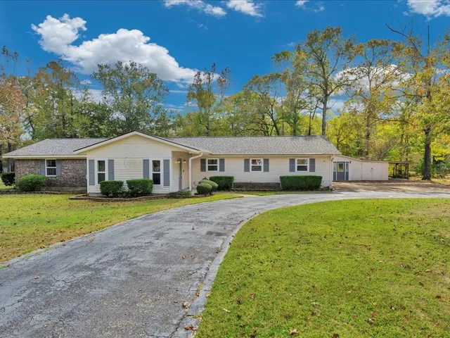 a front view of a house with garden