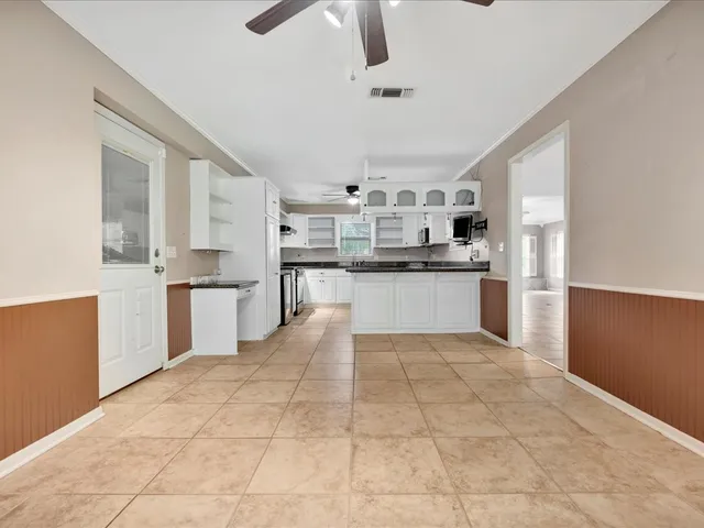 a large kitchen with cabinets and stainless steel appliances