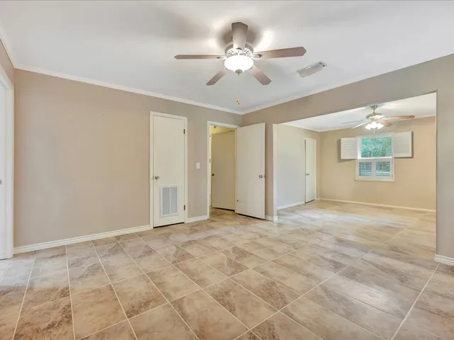 a view of an empty room with a ceiling fan