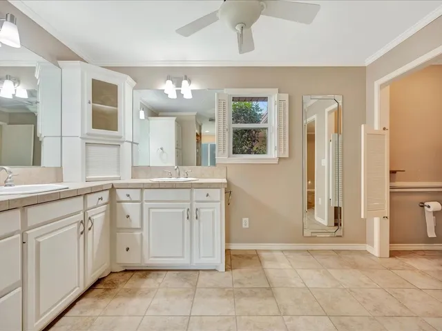 a spacious bathroom with a granite countertop sink mirror and a