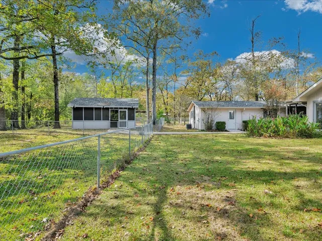a view of house with outdoor space and swimming pool