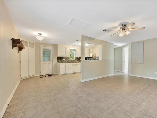 a view of a kitchen with a sink and a refrigerator