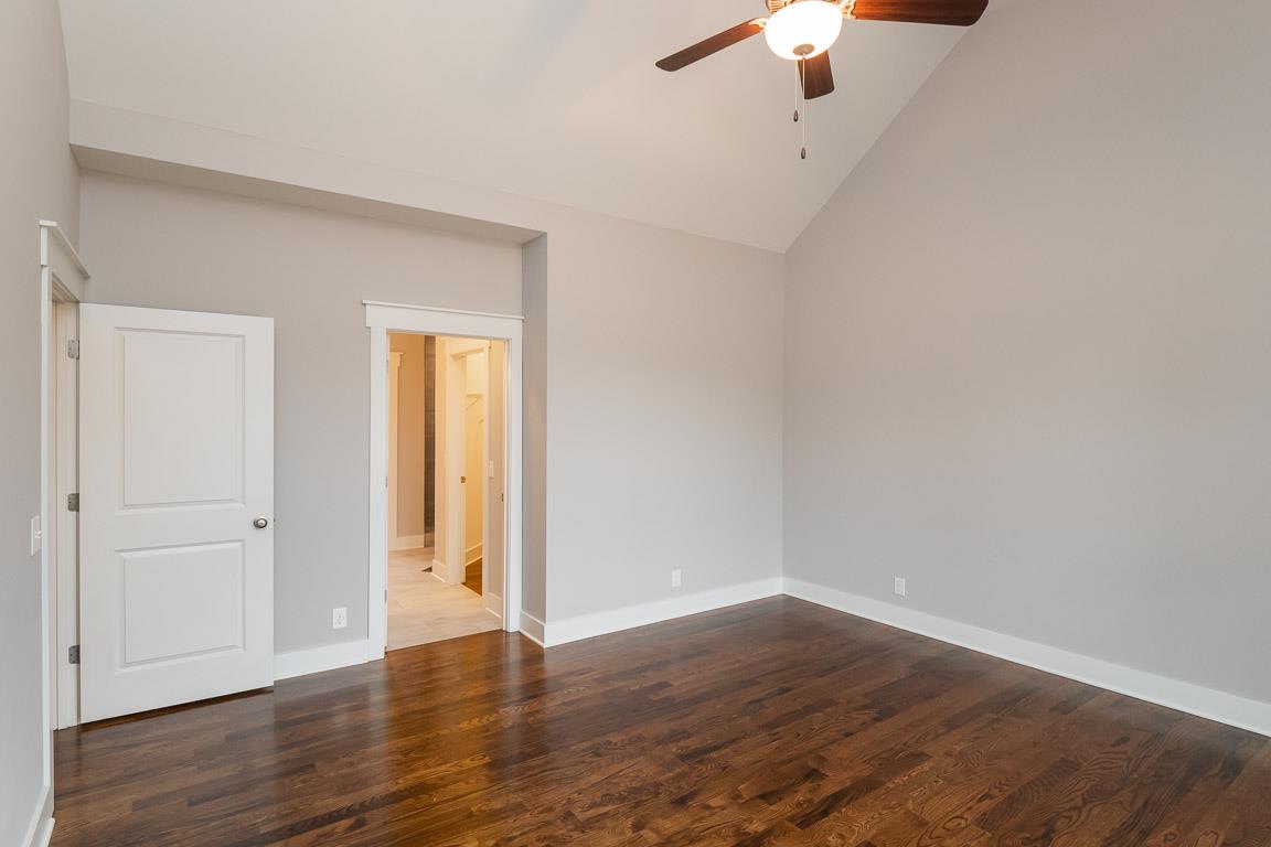 6617 Herbert Shannon Road Springfield, TN 37172 - Photo 21 of 30 a view of an empty room with wooden floor a ceiling fan
