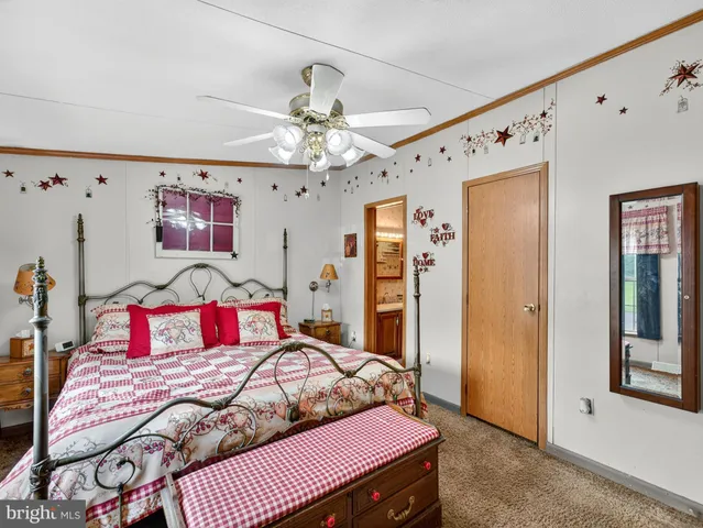 a bedroom with a bed dresser and window