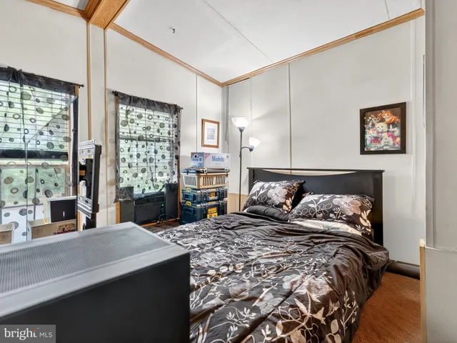 a bed sitting in a bedroom next to a window