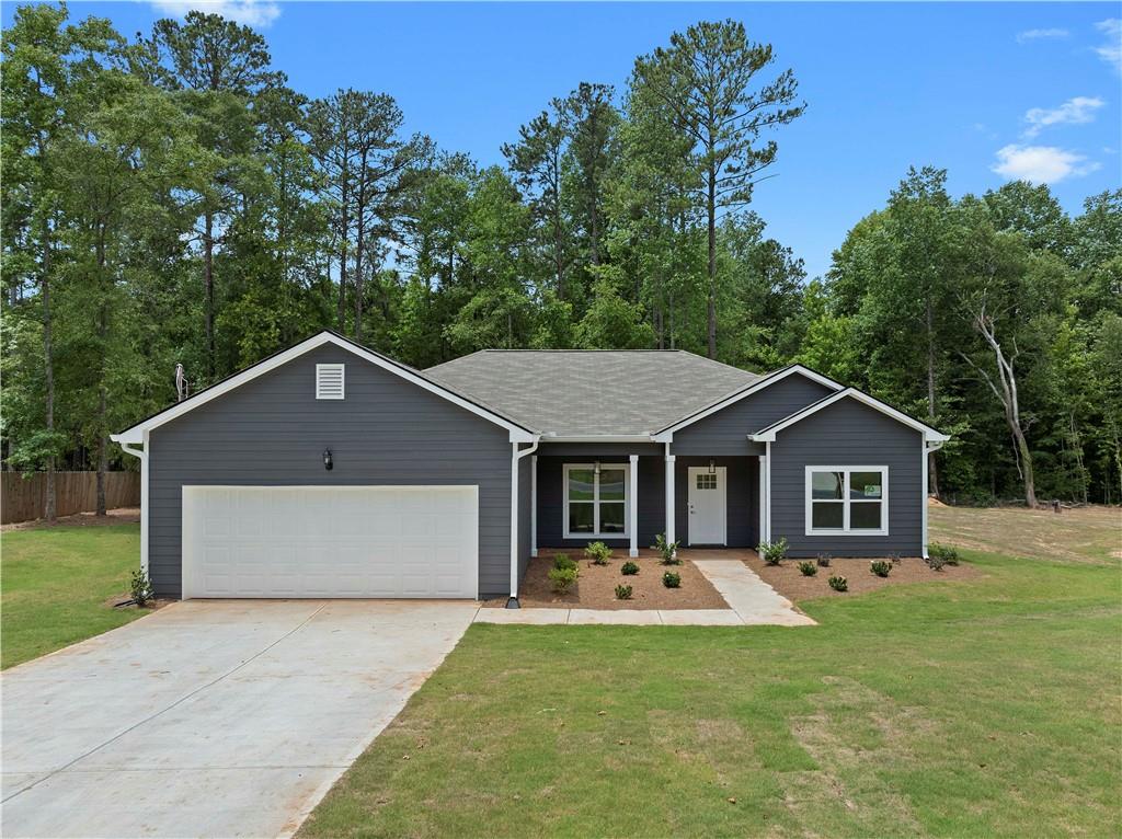 a front view of a house with a yard and trees