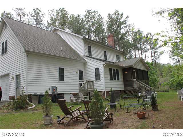 68 Rivers Bend Lane Bumpass, VA 23024 - Photo 23 of 24 Yard/Garden - Rear view of the house, yard and scr