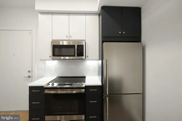 a kitchen with stainless steel appliances granite countertop a stove and a refrigerator