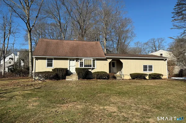 a view of a house with a yard covered with snow in front of house