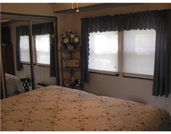 301 Bulgarmarsh Road, Unit T 76 Tiverton, RI 02878 - Photo 6 of 8 a bedroom with a bed and a window