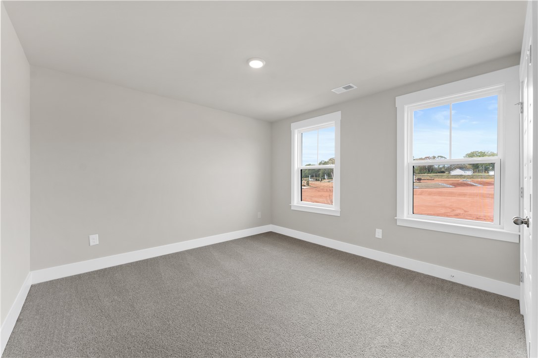 167 Tiger Lily Drive Anderson, SC 29621 - Photo 16 of 34 An airy bedroom with dual windows and a neutral palette awaits your personal touch.