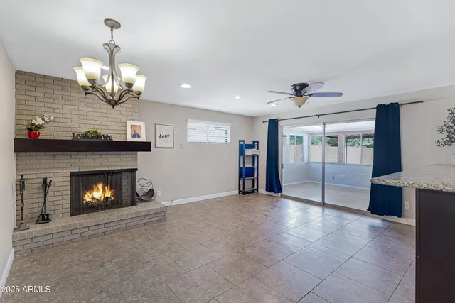 a view of an empty room with a fireplace and window