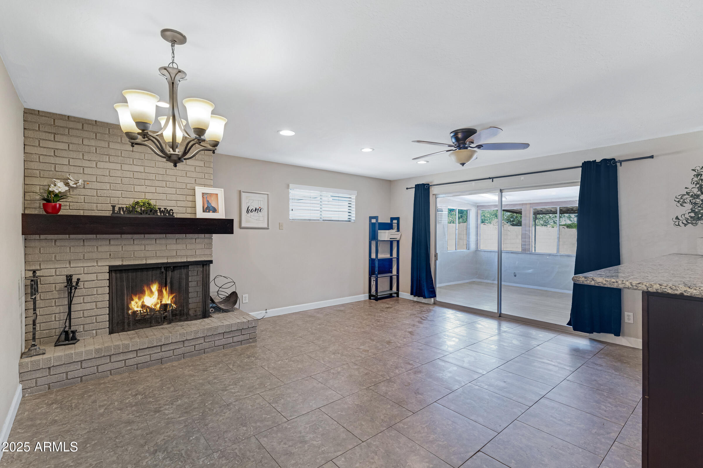a view of an empty room with a fireplace and window