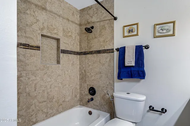 a bathroom with a toilet a sink and bathtub