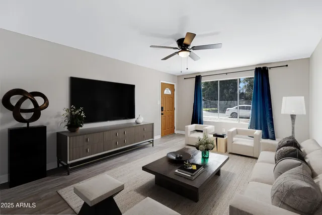 a living room with furniture and a flat screen tv