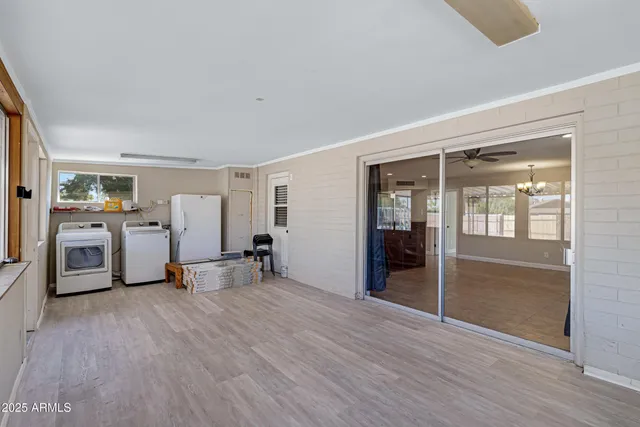 a view of a livingroom with furniture wooden floor and window