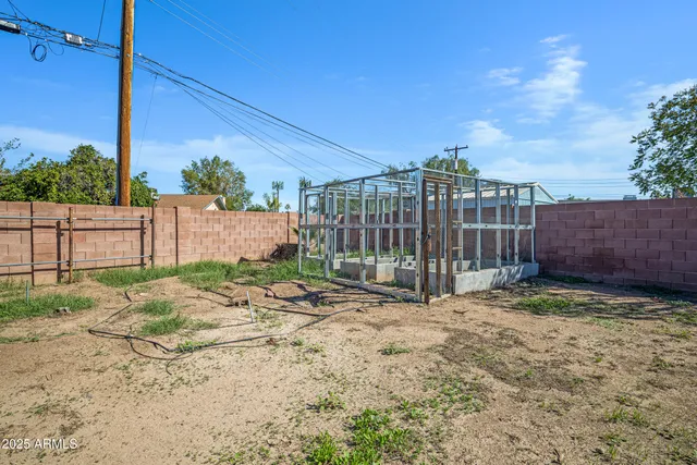 a view of a backyard with wooden fence