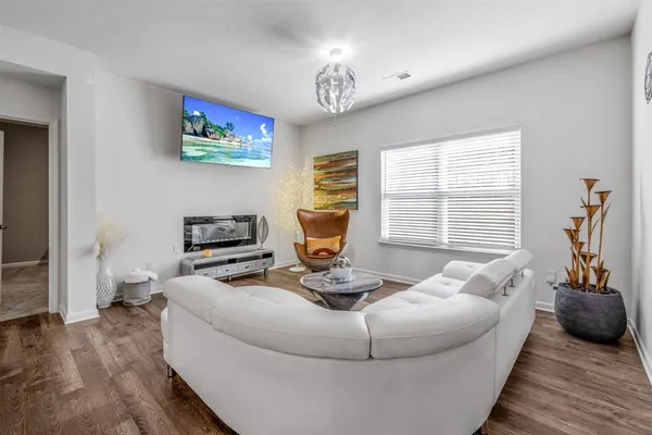 a kitchen with stainless steel appliances a dining table chairs and a refrigerator