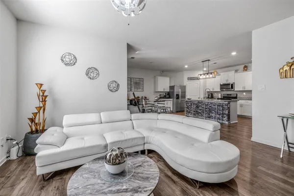 a view of a dining room with furniture wooden floor and a potted plant
