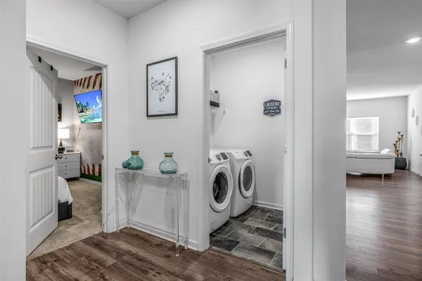 a bedroom with a bed and a wall painting