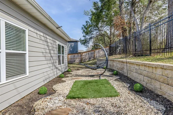 a view of house with backyard and sitting area